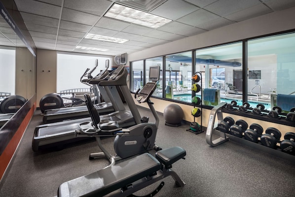 A gym with treadmills, elliptical machines, and a weight rack. - Hampton Inn-Denver West/Golden (Golden)