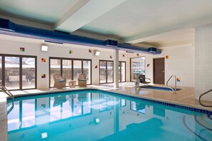 Relax by the pool surrounded by a spacious deck and lounge chairs.