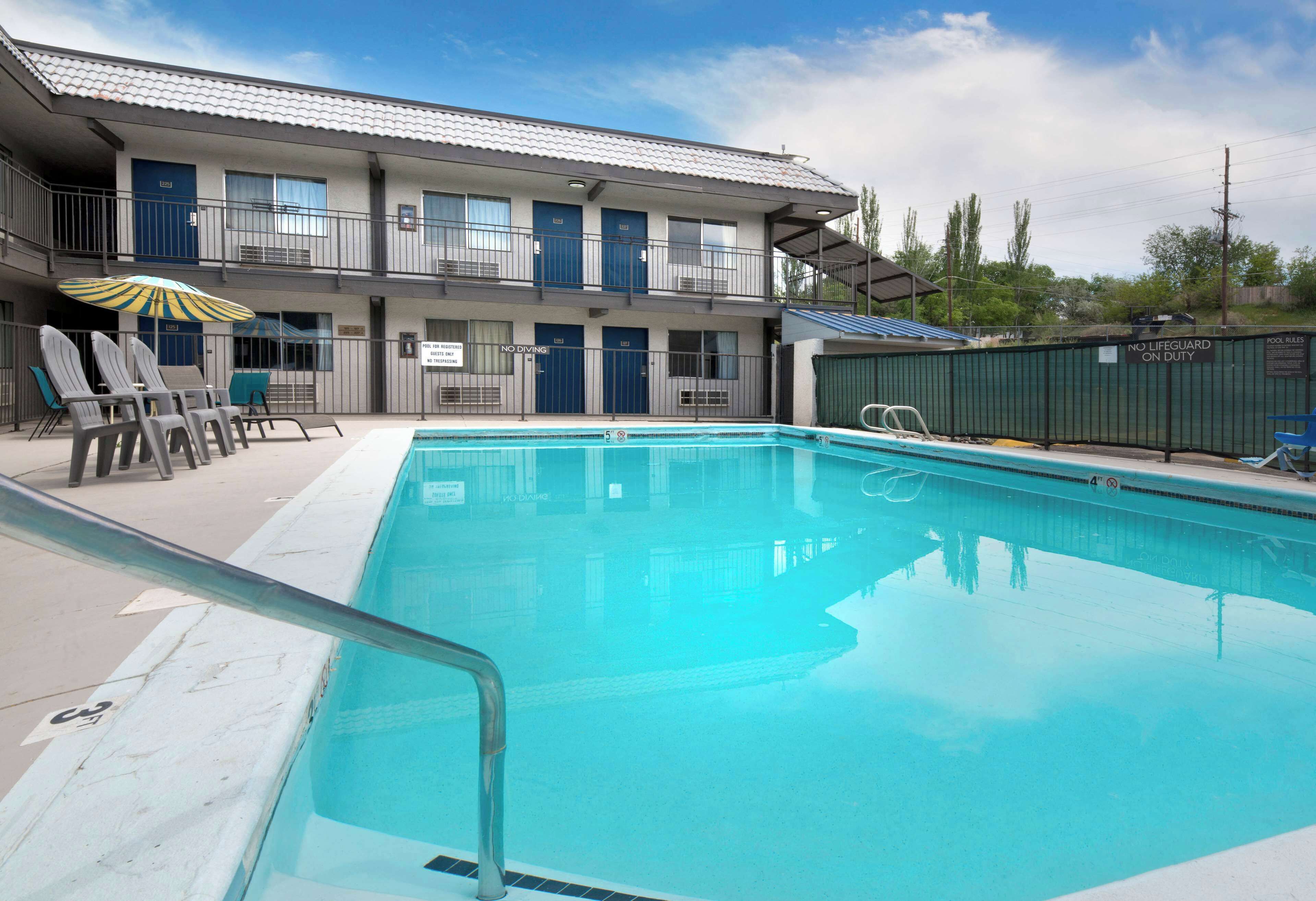 Seasonal outdoor pool, open 10:00 AM to 10:00 PM, pool umbrellas
