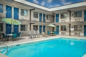 Seasonal outdoor pool, open 10:00 AM to 10:00 PM, pool umbrellas