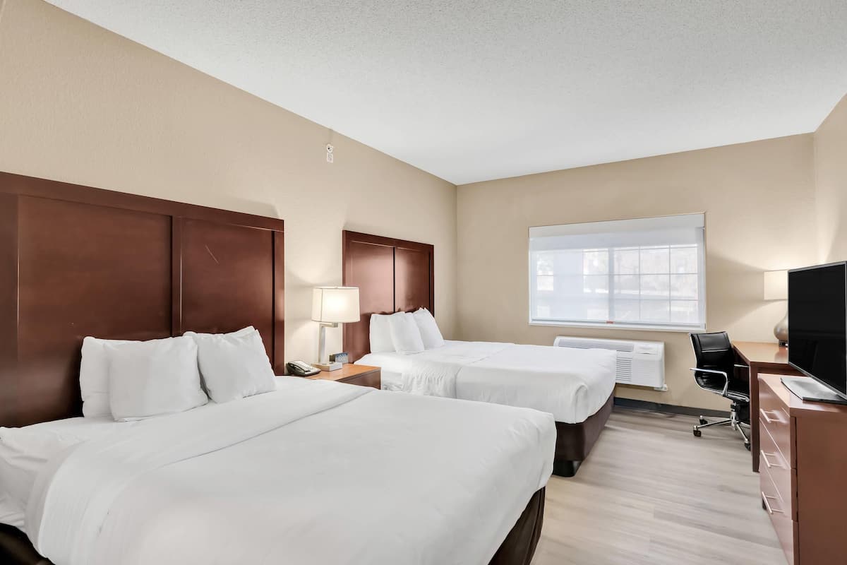 Suite, 2 Queen Beds with Sofa Bed, Non smoking | Desk, laptop workspace, blackout drapes, iron/ironing board