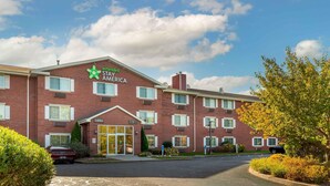 A Stay America hotel with a brick facade, multiple windows, and a visible lobby entrance. - Extended Stay America Suites Hartford Farmington (Farmington)