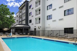 Relax by the pool with lounge chairs and umbrellas.