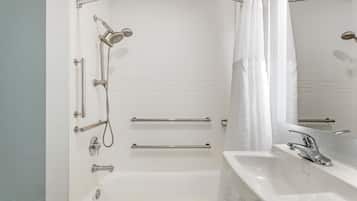 A bathroom with a bathtub, a sink, and a shower.