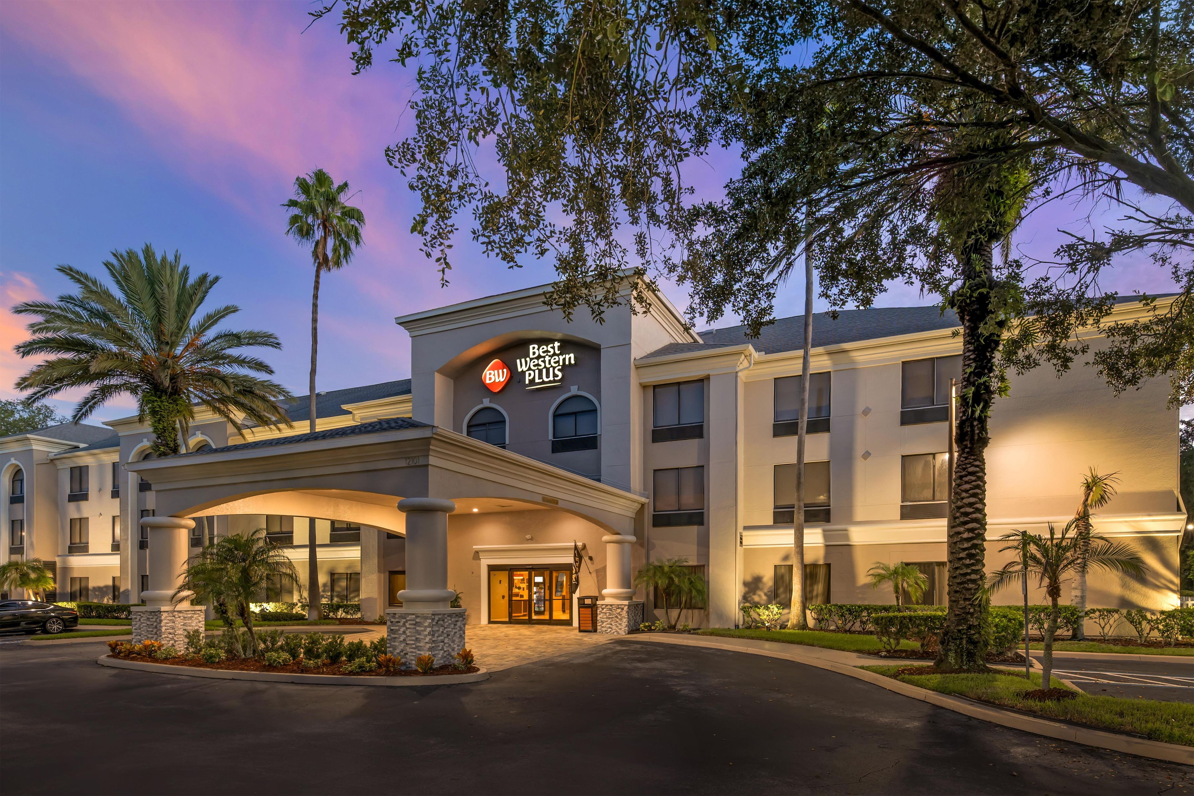 A hotel entrance with a sign reading 'Best Western PLUS,' featuring a modern architectural style with a flat roof and large windows.