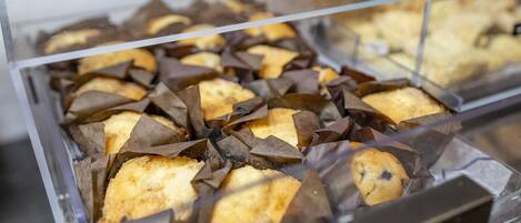 A display case containing various baked goods, likely in a bakery or cafe setting.