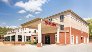 A two-story building with a covered entrance labeled "RAMADA." - Ramada by Wyndham Alpharetta/Atlanta North (Alpharetta)