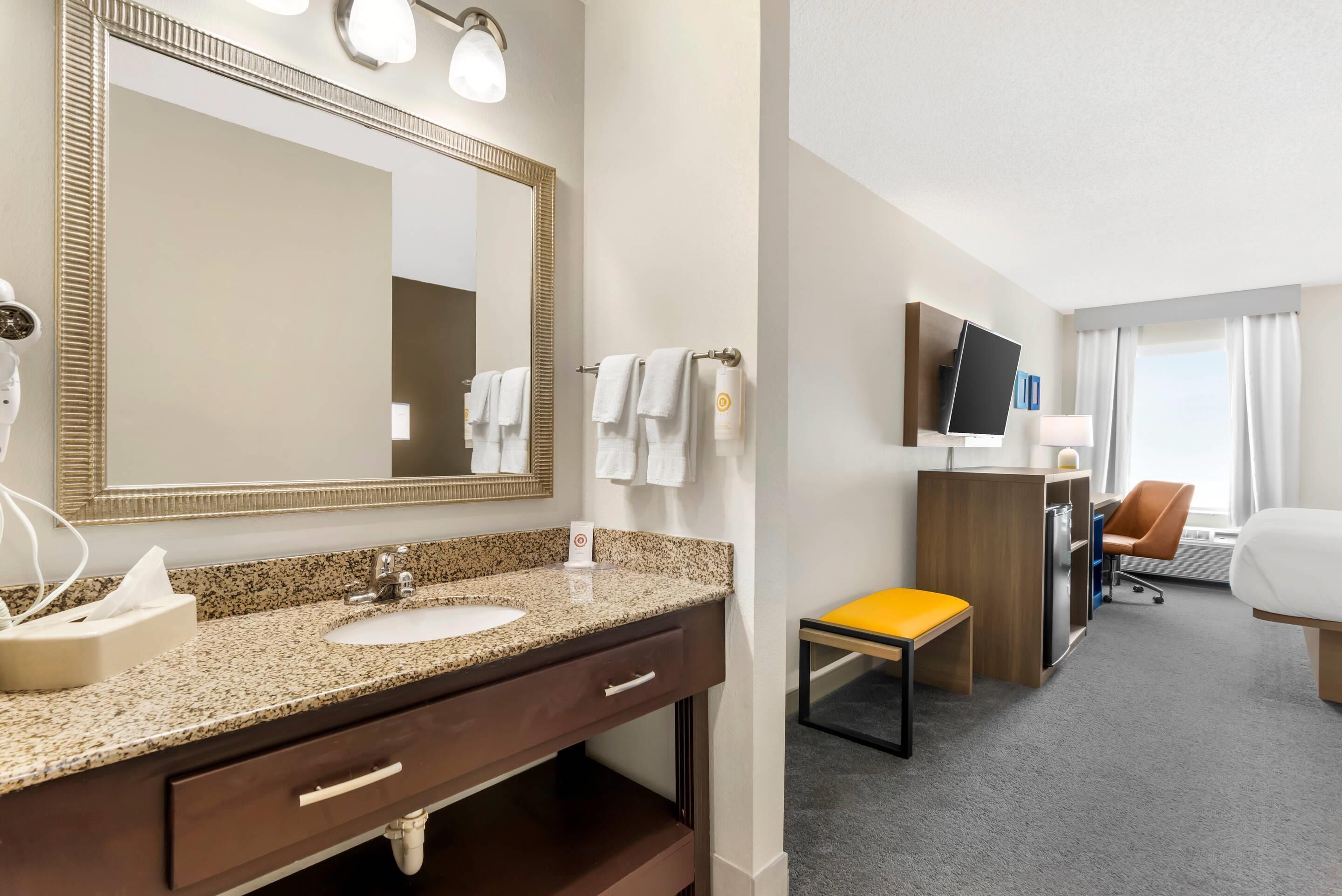 Premium bedding, desk, laptop workspace, blackout drapes
