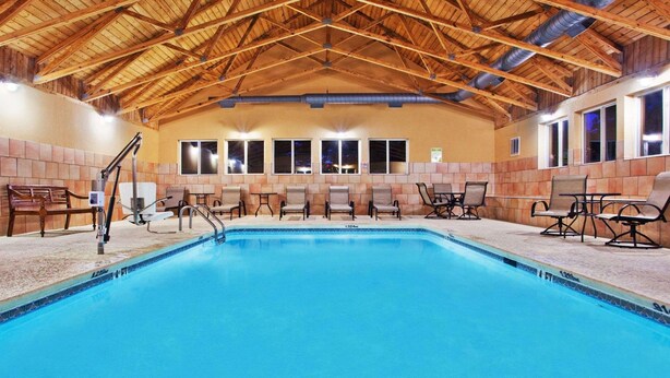 An indoor swimming pool with a wooden ceiling, tiled walls, and multiple windows. - Comfort Inn Blairsville Butternut Creek (Blairsville)