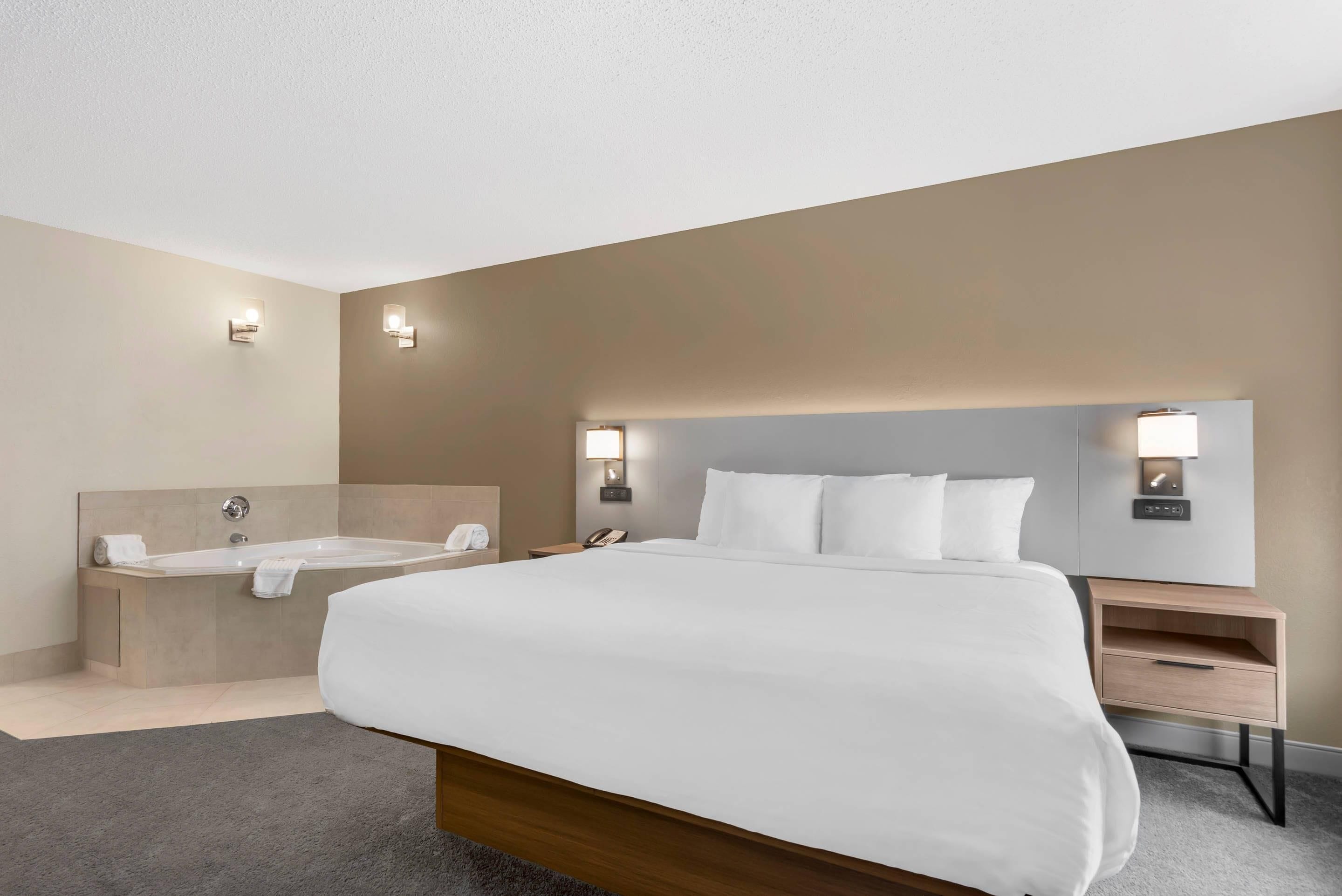 Premium bedding, desk, laptop workspace, blackout drapes