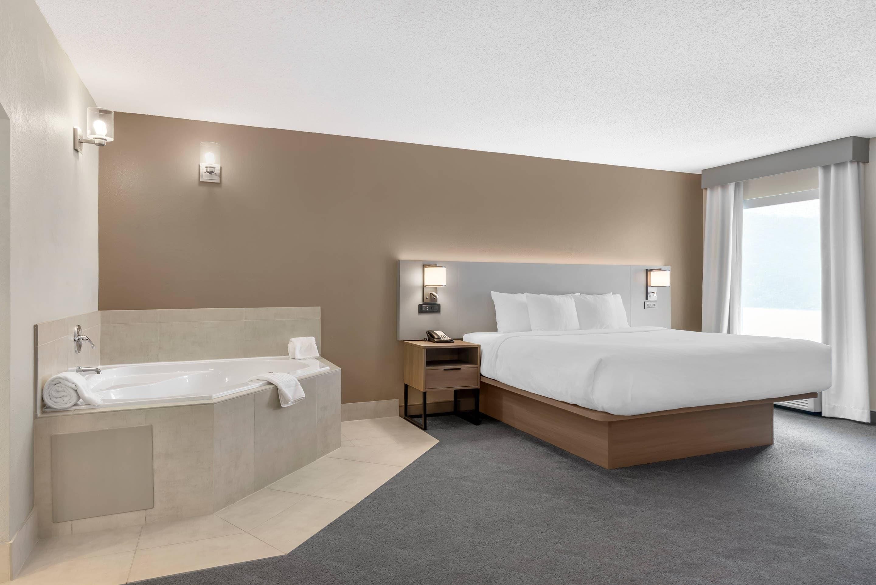 Premium bedding, desk, laptop workspace, blackout drapes