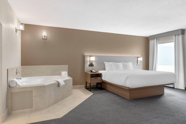 Premium bedding, desk, laptop workspace, blackout drapes