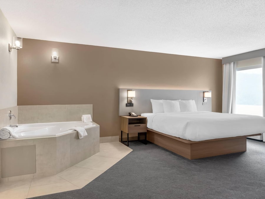 Premium bedding, desk, laptop workspace, blackout drapes