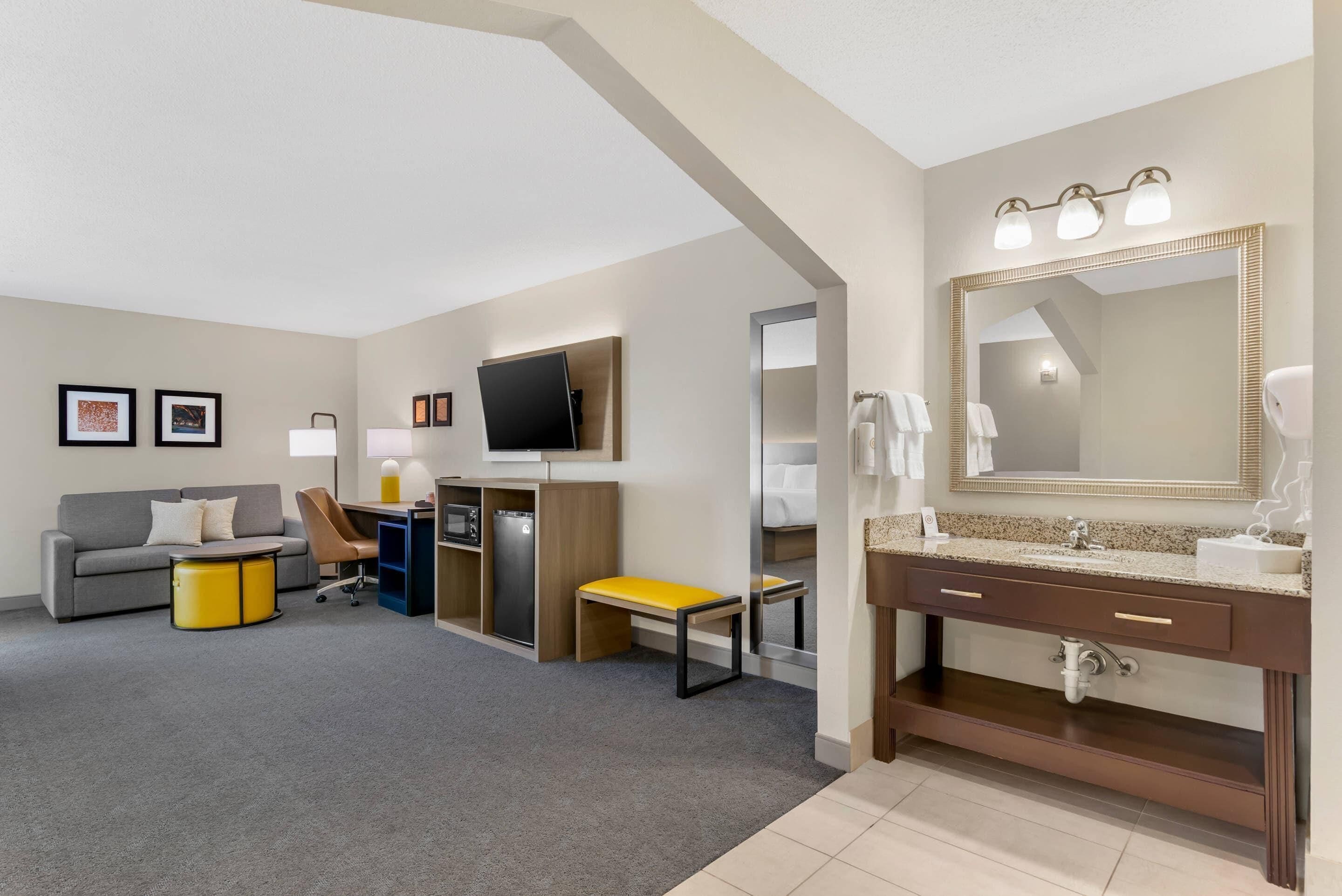 Premium bedding, desk, laptop workspace, blackout drapes