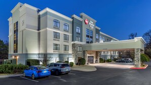 A Best Western Plus hotel with a modern design, featuring a large parking lot and a well-lit entrance. - Best Western Plus Dalton Inn (Dalton)