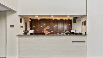 A reception desk with a modern design, a crescent moon motif, and two computer stations.