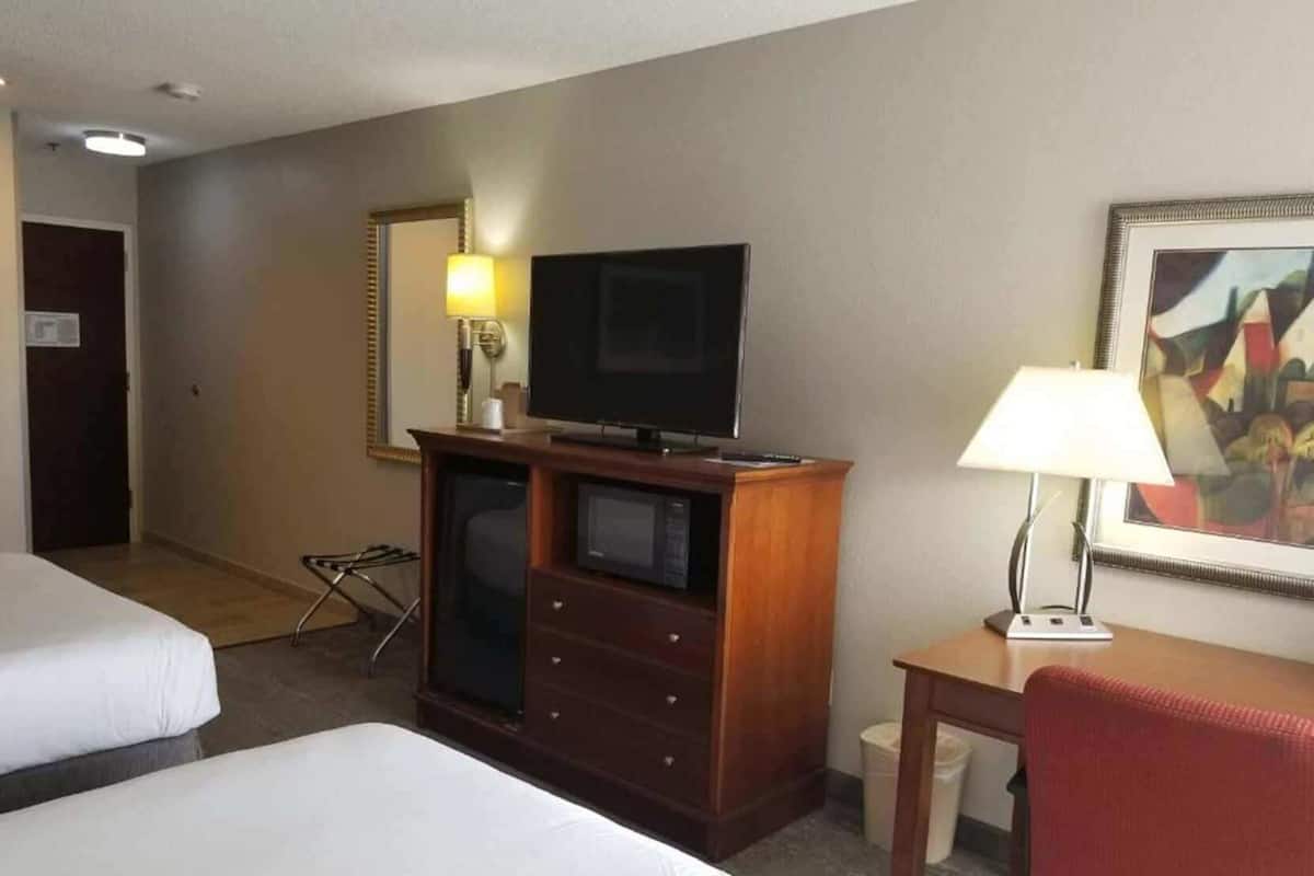 Desk, laptop workspace, blackout drapes, iron/ironing board