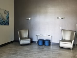 Relax in a serene space with two comfortable armchairs and a small table.