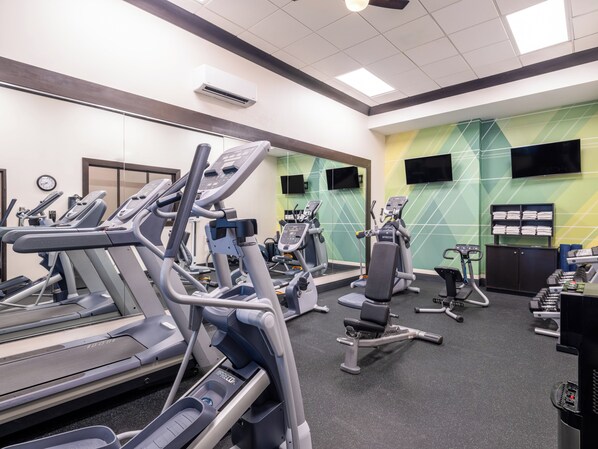 A gym with treadmills, elliptical machines, and weight benches. - Holiday Inn Chicago Northwest-Elgin by IHG (Elgin)