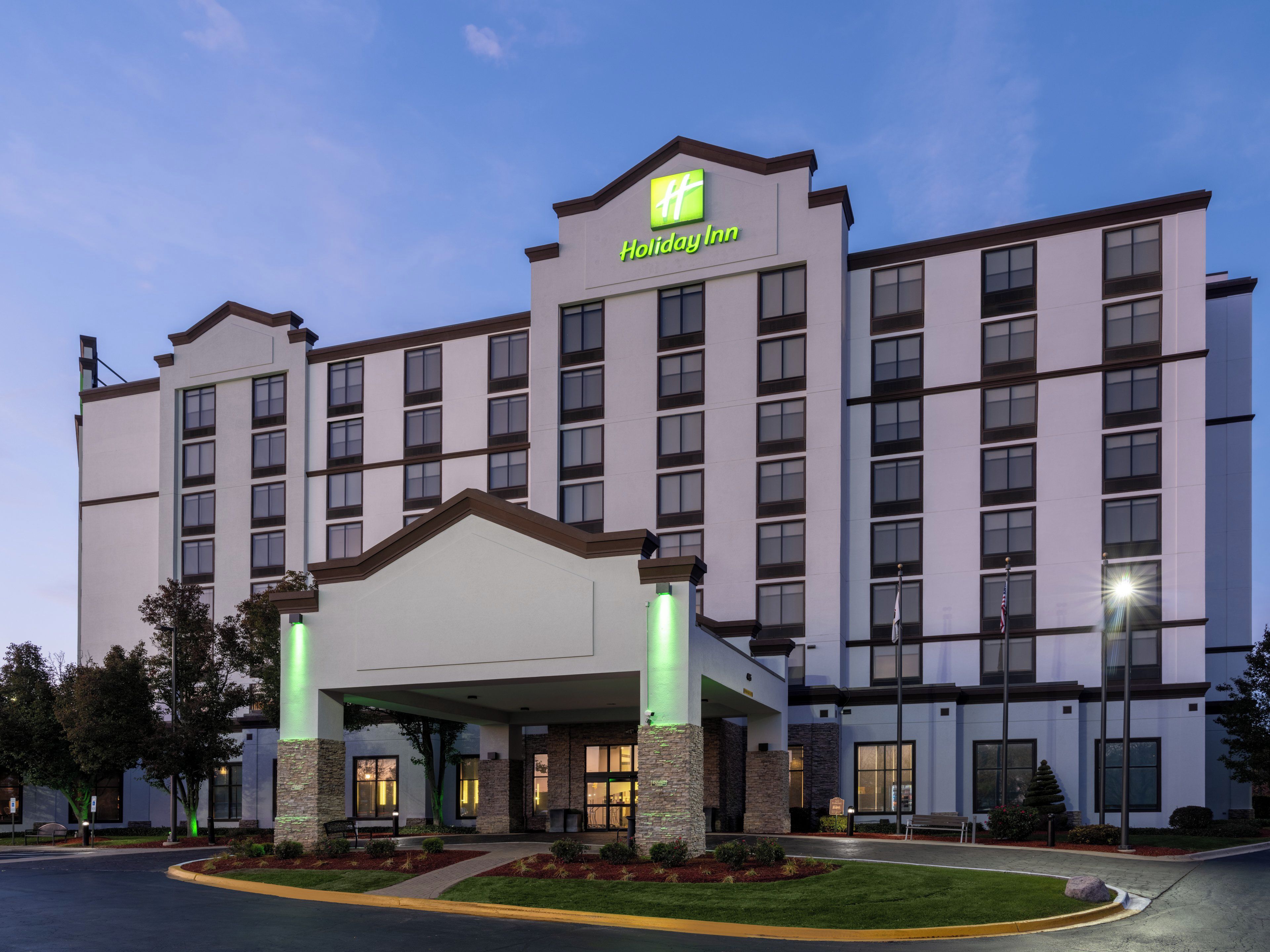 A Holiday Inn hotel with a modern design, featuring a large entrance and multiple floors.