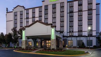 A Holiday Inn hotel with a modern design, featuring a large entrance and multiple floors.