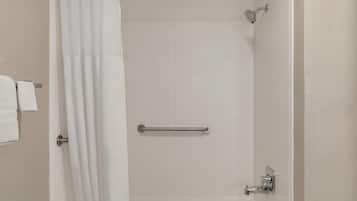Eine Dusche mit Haltegriff, Handtuchhalter und Duschkopf.
