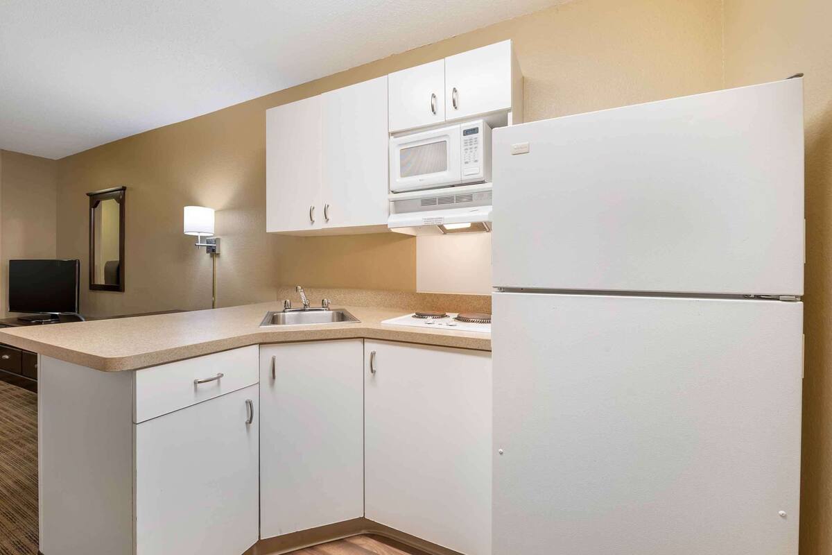 desk, laptop workspace, blackout curtains, iron/ironing board