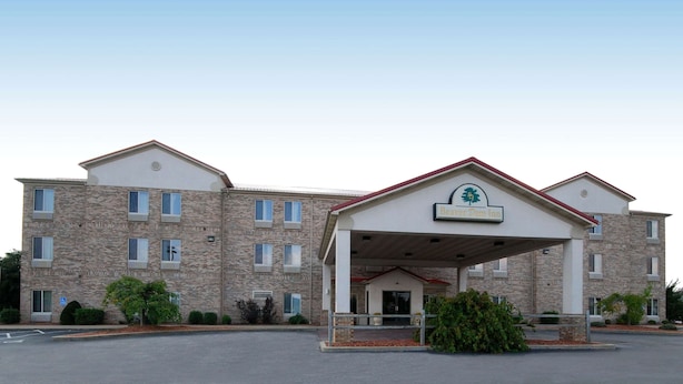 A multi-story building with a covered entrance and a sign for Beaver Dam Inn.