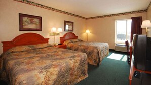 A hotel room with two beds, a television, and a window with curtains. - Beaver Dam Inn (Beaver Dam)
