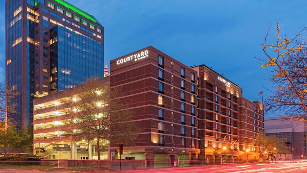 A Courtyard by Marriott hotel with a modern brick facade, multiple floors, and a prominent sign. - Courtyard by Marriott Louisville Downtown (Louisville)