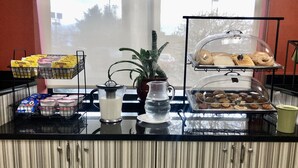 A breakfast buffet with various food items and a pitcher of milk. - Ramada Limited Mount Sterling (Mount Sterling)