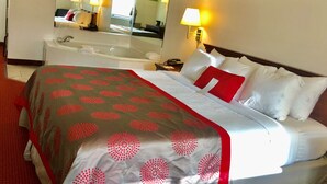 A hotel room with a bed, a bathroom, and a large mirror. - Ramada Limited Mount Sterling (Mount Sterling)