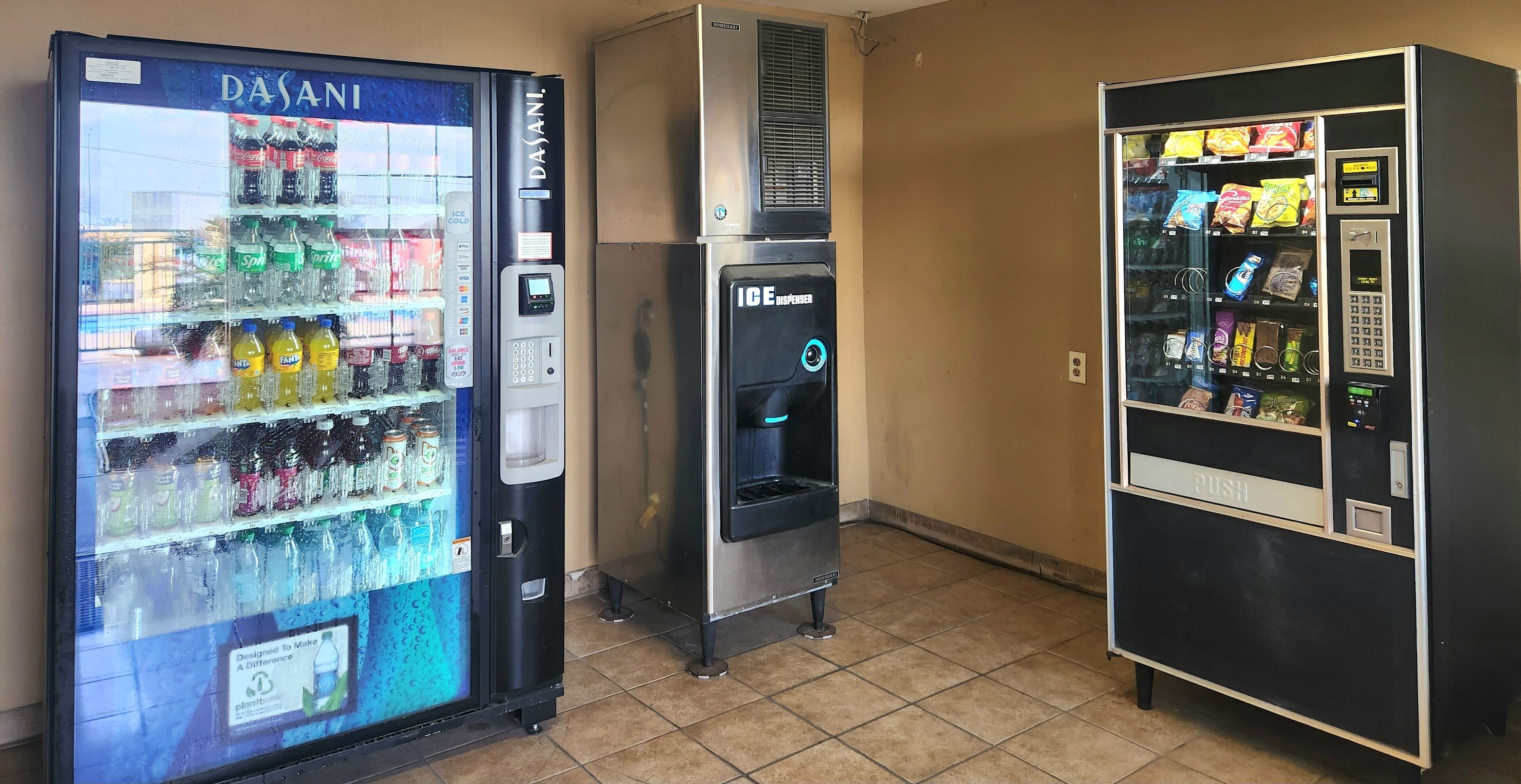 A vending machine area with a Dasani water dispenser, an ICE+ dispenser, and a push vending machine.