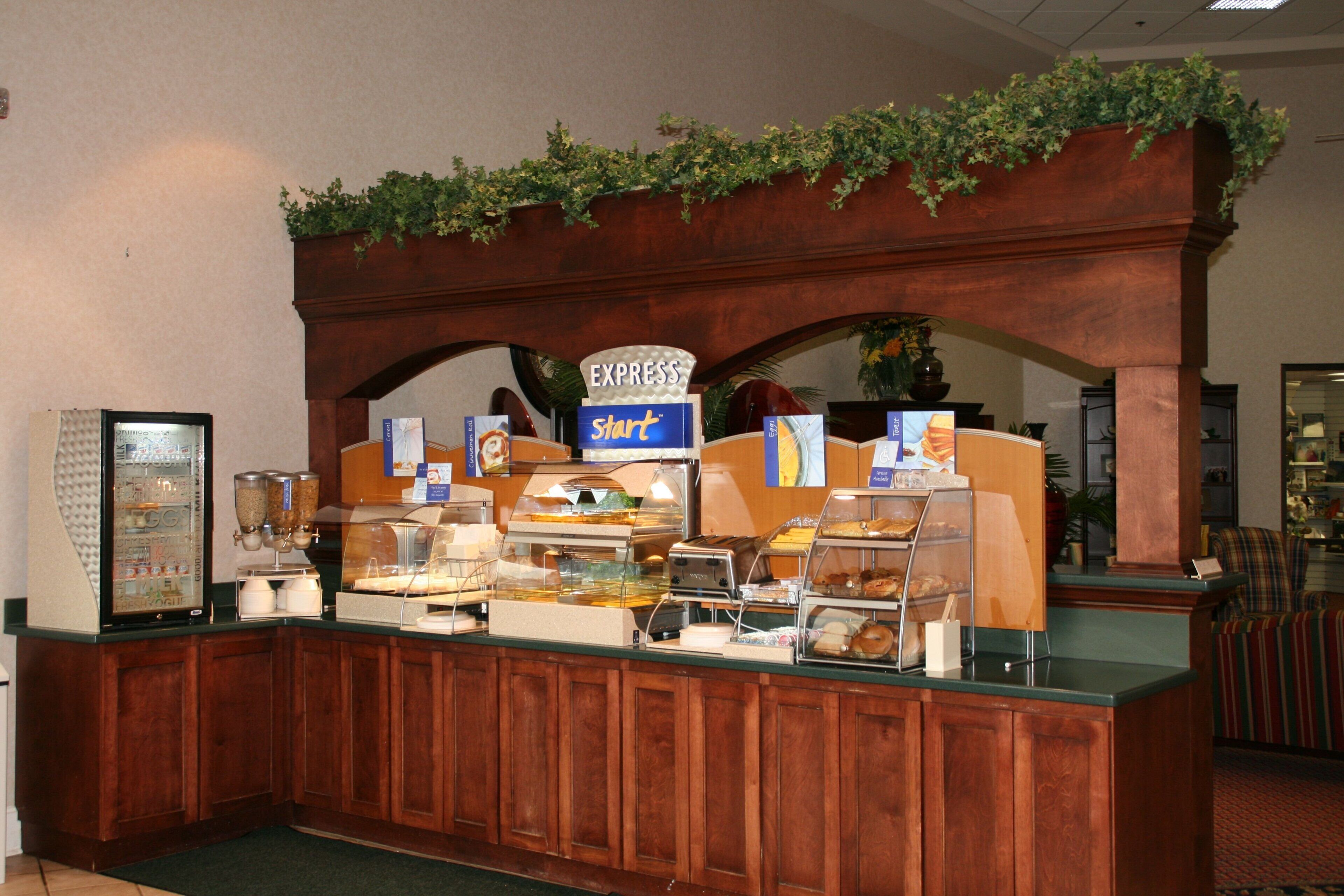 A buffet counter with various food items and a sign that reads 'EXPRESS Start'.