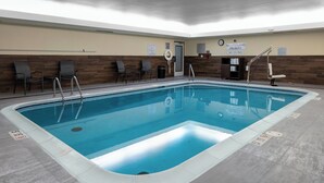 An indoor swimming pool with clear water, surrounded by lounge chairs and a wooden wall. - Fairfield Inn & Suites by Marriott - Jefferson City (Jefferson City)