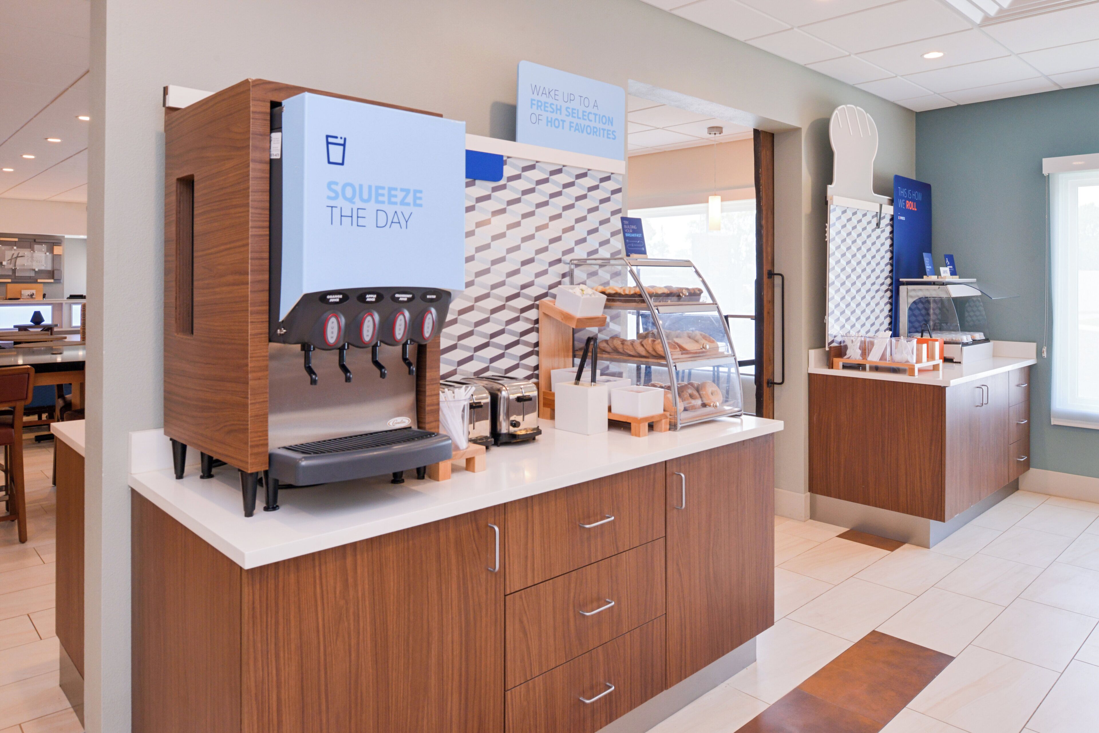A coffee station with a branded coffee machine and a sign that reads 'SQUEEZE THE DAY'.