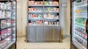 A refrigerated display case with various snacks and beverages.