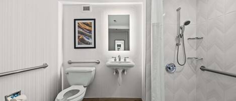 Un baño moderno con inodoro, lavamanos y ducha.