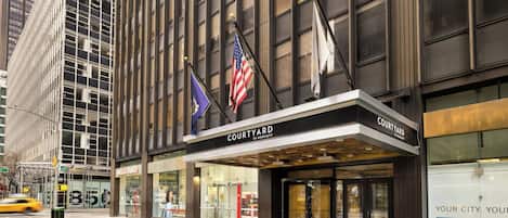 A hotel with a modern facade, large windows, and a prominent entrance.
