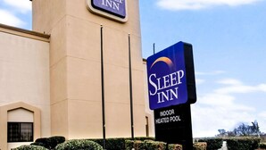 A Sleep Inn hotel with a sign indicating an indoor heated pool.