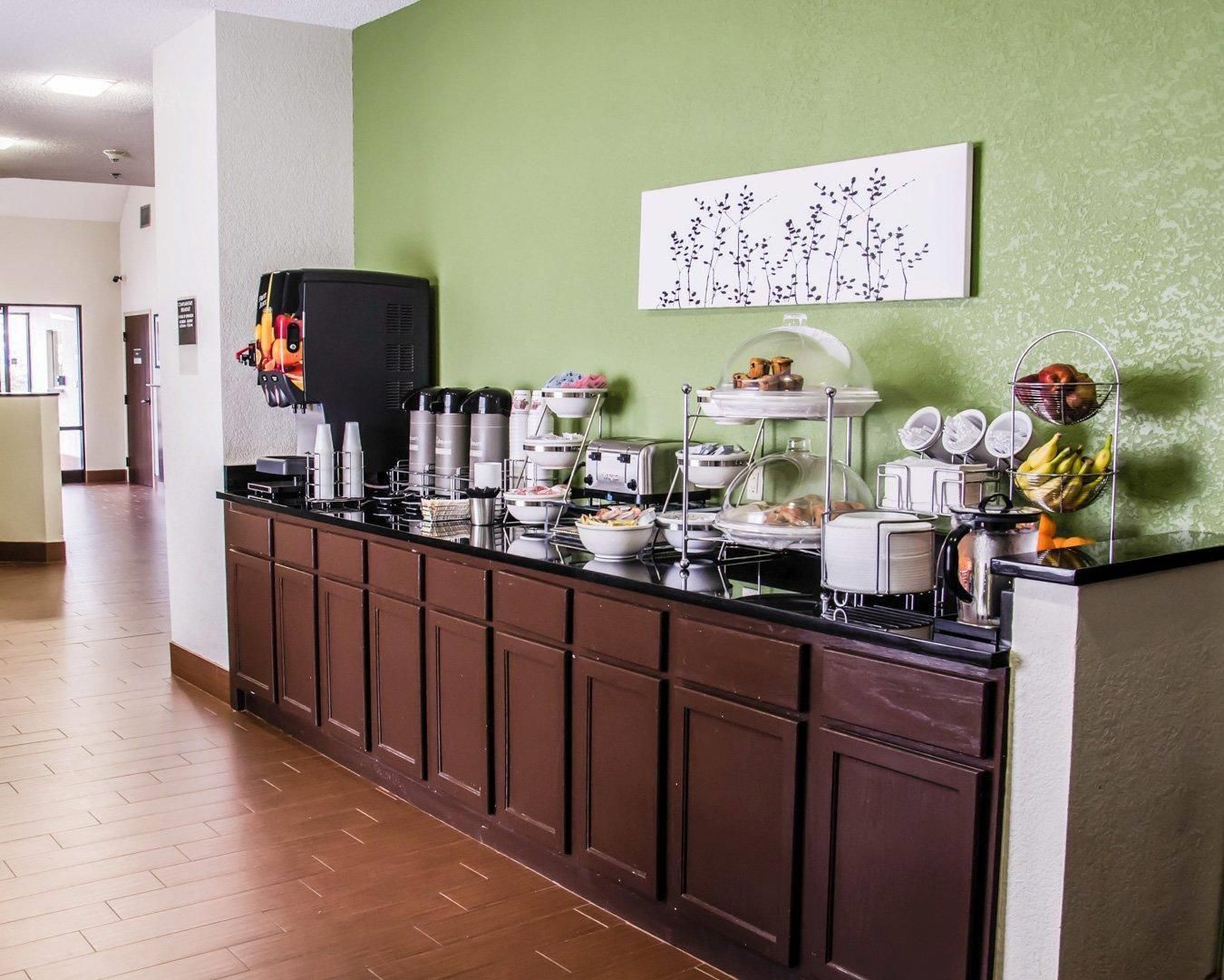 A buffet setup with various food items and condiments.