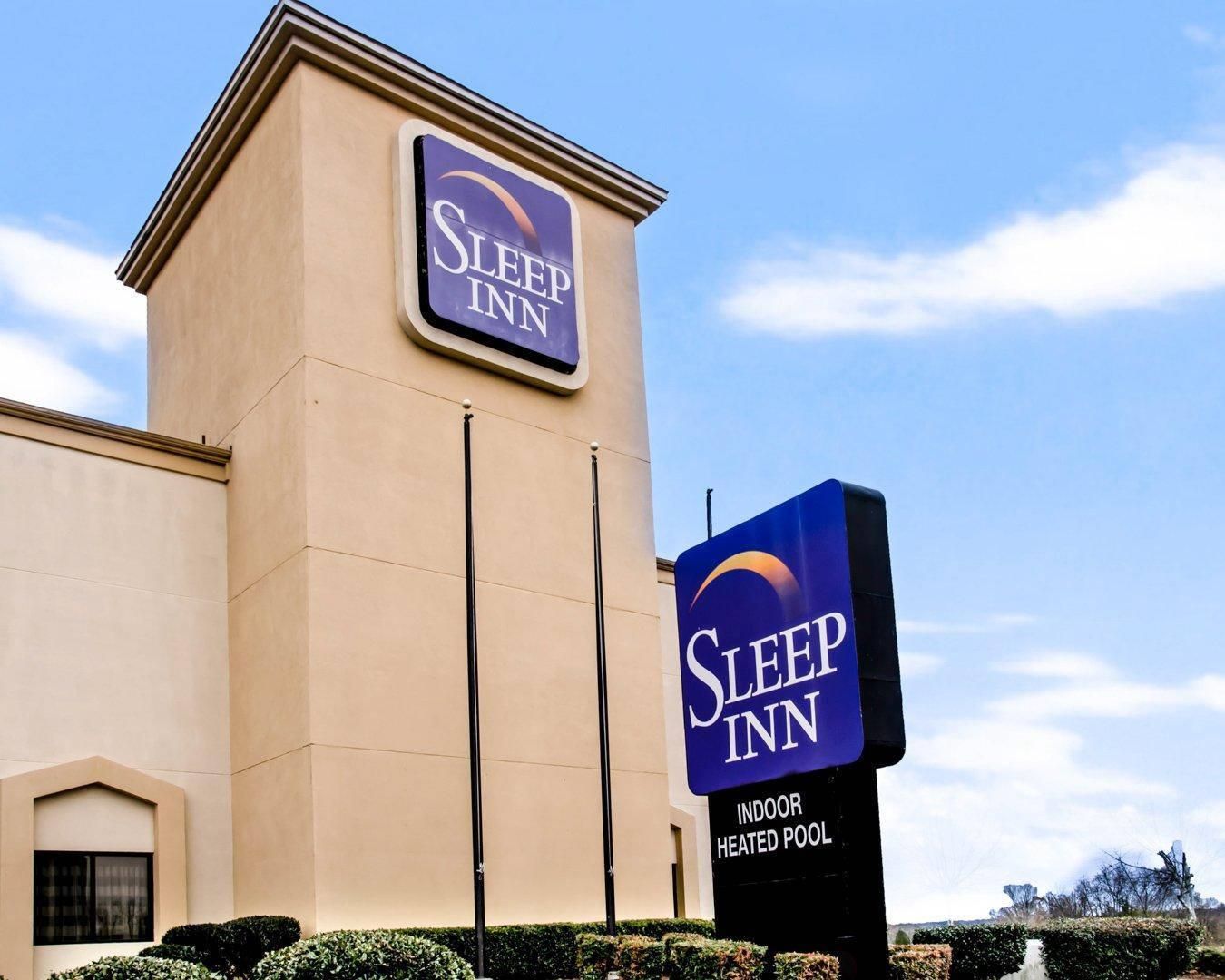 A Sleep Inn hotel with a sign indicating an indoor heated pool.