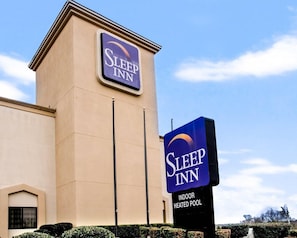 A Sleep Inn hotel with a sign indicating an indoor heated pool.