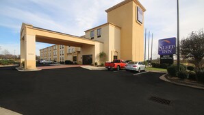 A Sleep Inn hotel with a large parking lot, a red pickup truck, and a sign indicating an indoor heated pool. - Sleep Inn Concord - Kannapolis (Concord)