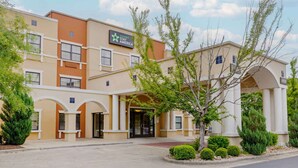 A hotel with a beige facade, multiple windows, and a sign reading "Extended Stay America." - Extended Stay America Suites - Fayetteville - Fort Bragg (Fayetteville)