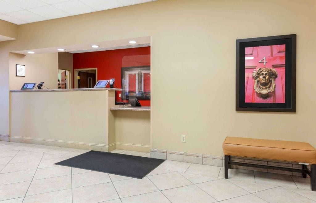 A reception area with a desk, a bench, and a framed artwork on the wall.