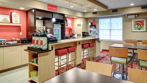 A modern breakfast area with a counter, seating, and a refrigerator. - Towneplace Suites By Marriott Cleveland Westlake (Westlake)