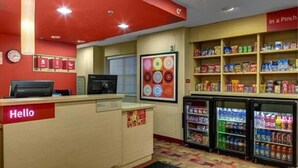 A brightly lit snack bar with a 'Hello' sign, a clock, and a refrigerator stocked with beverages. - Towneplace Suites By Marriott Cleveland Westlake (Westlake)