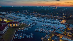 A marina with numerous boats docked, surrounded by buildings and a clear sky. - Holiday Inn Express N.Myrtle Beach- Little River by IHG (Little River)