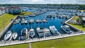 A marina with numerous boats docked, surrounded by buildings and greenery. - Holiday Inn Express N.Myrtle Beach- Little River by IHG (Little River)